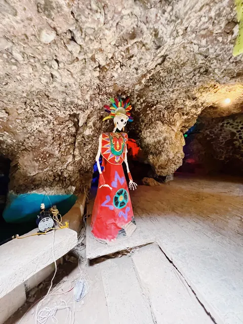 A colorful cultural figure in a cave