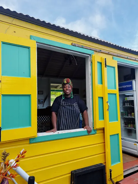Local chef at a yellow window in Nevis