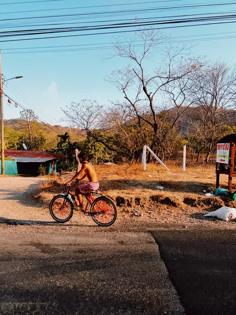 A cyclist on a tropical road in Las Catalinas